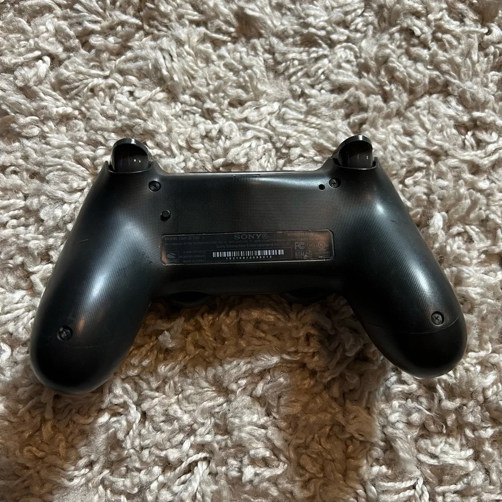 Sony dual shock modified PS4 controller, black and gold with hard case.